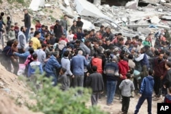 غزہ شہر میں فلسطینی فضائی ذریعے سے گرائی جانے والی امداد اکٹھی کرنے کی کوشش کررہے ہیں، فوٹو اے پی، 17 مارچ2027
